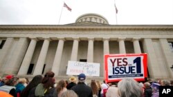 FILE - Supporters of Issue 1 attend a rally for the Right to Reproductive Freedom amendment held by Ohioans United for Reproductive Rights at the Ohio State House in Columbus, Ohio, Oct. 8, 2023. 