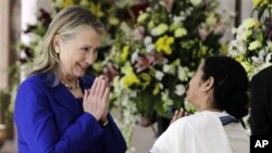 West Bengal Chief Minister Mamata Banerjee, right, and U.S. Secretary of State Hillary Rodham Clinton greet each other before a meeting in Kolkata, India, Monday, May 7, 2012.