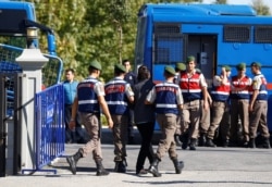 FILE - An unidentified solider accused of attempting to assassinate Turkey’s president during the failed attempted coup is escorted to a court hearing, Oct. 4, 2017.