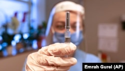 一名来自土耳其伊斯坦布尔的护士手持中国科兴控股生物技术有限公司生产的新冠病毒疫苗。（2020年12月21日）