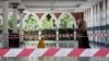 A woman wearing a protective mask walks at a mosque following the outbreak of coronavirus, in Kuala Lumpur, Malaysia March 16, 2020. REUTERS/Lim Huey Teng