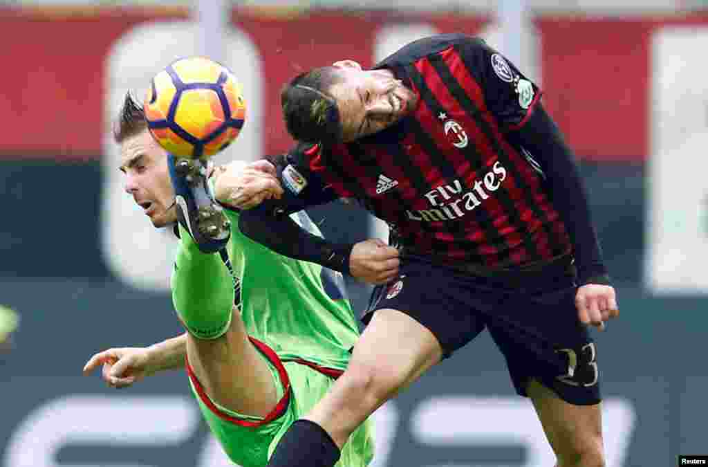 AC Milan's Jose Ernesto Sosa fights for the ball with Leonardo Capezzi of Crotone during the Italian Serie A football match at the San Siro stadium, Milan.