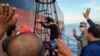 BAKAMLA melepaskan ABK kapal tanker Iran MT Horse untuk menaiki kapal mereka di lepas pantai Kepulauan Riau, sebelum meninggalkan perairan Indonesia, 29 Mei 2021. (BAKAMLA/AFP)