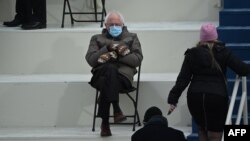 Senator Bernie Sanders sits in the bleachers on Capitol Hill before Joe Biden is sworn in as the 46th U.S. president, in Washington, Jan. 20, 2021.