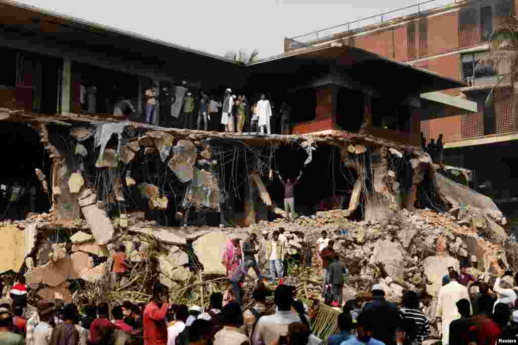 Protesters and observers gather to see the demolished Dhanmondi-32 residence of Bangabandhu Sheikh Mujibur Rahman, father of the ousted PM Sheikh Hasina, in Dhaka, Bangladesh.