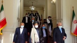 FILE - Iran's Foreign Minister Mohammad Javad Zarif meets with Taliban political chief Mullah Abdul Ghani Baradar, in Tehran, Iran, Jan. 31, 2021.