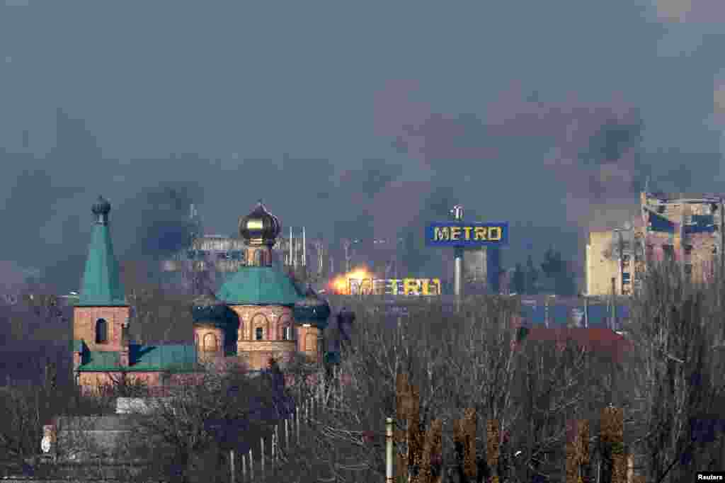 Smoke rises above an old terminal and an airport administrative building after the recent fighting between pro-Russian separatists and Ukrainian government forces in Donetsk, eastern Ukraine, Nov. 9, 2014.