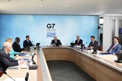 FILE - G-7 summit participants are seen during a session in Cornwall, England, June 12, 2021.