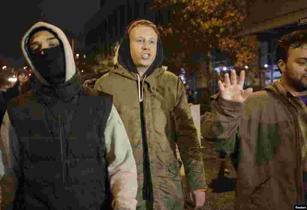 Rapper Macklemore walks with demonstrators following the grand jury decision in the fatal shooting of Michael Brown, in Seattle, Washington, Nov. 24, 2014.