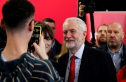 Britain's opposition Labour Party leader Jeremy Corbyn poses for a photo after speaking at a campaign event in Lancaster, England, Nov. 15, 2019.