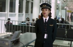 FILE - Ethiopian Airlines' first female captain Amsale Gualu waits to be cleared to board before takeoff at Bole international airport in the capital Addis Ababa, Nov. 18, 2015.