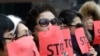 FILE - In this Jan. 26, 2015, photo, defectors from North Korea cover their faces with placards as a safety precaution for their relatives still living in the North, during a rally to protest human rights abuses in North Korea, in Seoul, South Korea.