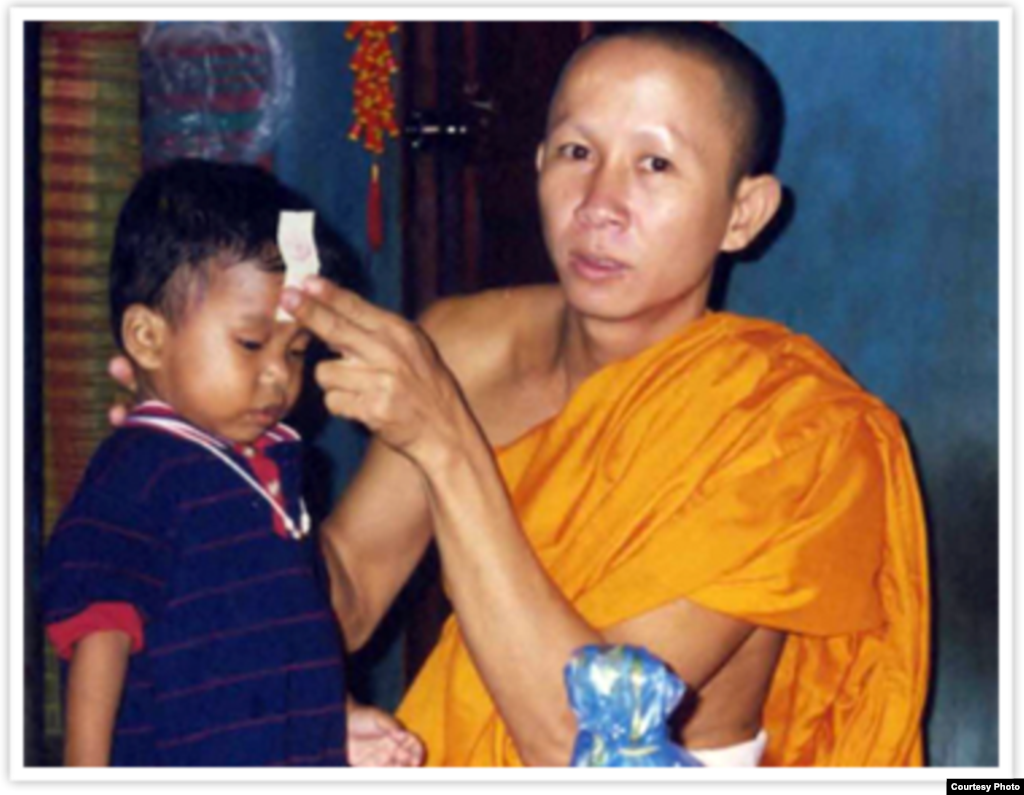 A Buddhist monk blesses the two-years old Jordan Pisey Windle before he left his homeland to start an inspiring journey with his single parent, Jerry Windle, in Florida, United States. (Courtesy Photo)
