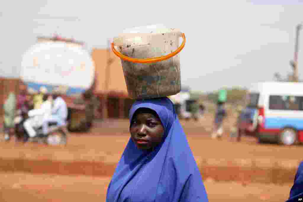 A woman sells cooked cabbage leaves on a road side market in Sokoto, Nigeria. (AP Photo/Sunday Alamba)