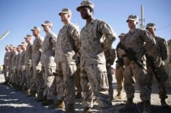U.S. Marines watch during a change of command ceremony at Task Force Southwest military field, Helmand province, Afghanistan, Jan. 15, 2018. The final phase of ending U.S. military involvement in Afghanistan began May 1, 2021.