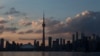 FILE - The sun sets on the Toronto skyline, July 10, 2015. 