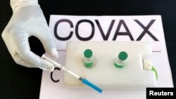 FILE - A nurse prepares to administer the AstraZeneca/Oxford vaccine under the COVAX scheme against the coronavirus disease (COVID-19) at the Eka Kotebe General Hospital in Addis Ababa, Ethiopia March 13, 2021. (REUTERS/Tiksa Negeri/File Photo)