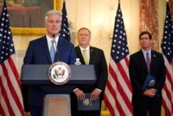 National Security Adviser Robert O'Brien speaks during a news conference on Sept. 21, 2020, at the U.S. State Department in Washington, as Secretary of State Mike Pompeo and Defense Secretary Mark Esper, right, listen.