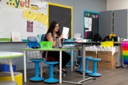 FILE - Ruth Harris virtually teaches a third-grade class at Wilson Primary School in Phoenix, Aug. 17, 2020.