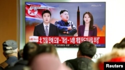 People watch a TV broadcasting a news report on North Korea firing what appeared to be an intercontinental ballistic missile (ICBM) that landed close to Japan, in Seoul, South Korea, Nov. 29, 2017. 