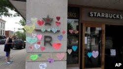 FILE - Hearts with messages in support of the Black Lives Matter movement are seen posted outside a Starbucks store in downtown Naperville, Illinois, June 4, 2020.