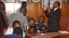 Minister of Health and Child Care Dr. Obadiah Moyo discuss with the junior doctors who are on strike at the Parirenyatwa hospital in Harare, Dec. 5, 2018. 