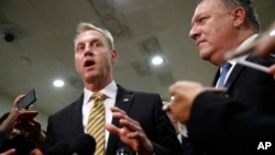 Acting Defense Secretary Patrick Shanahan, left, speaks to members of the media alongside Secretary of State Mike Pompeo after a classified briefing for members of Congress on Iran, on Capitol Hill in Washington, May 21, 2019. 