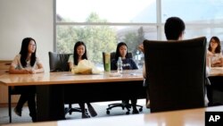 FILE - Students attend a meeting of a Chinese scholars association on the campus of the University of Connecticut in Storrs.