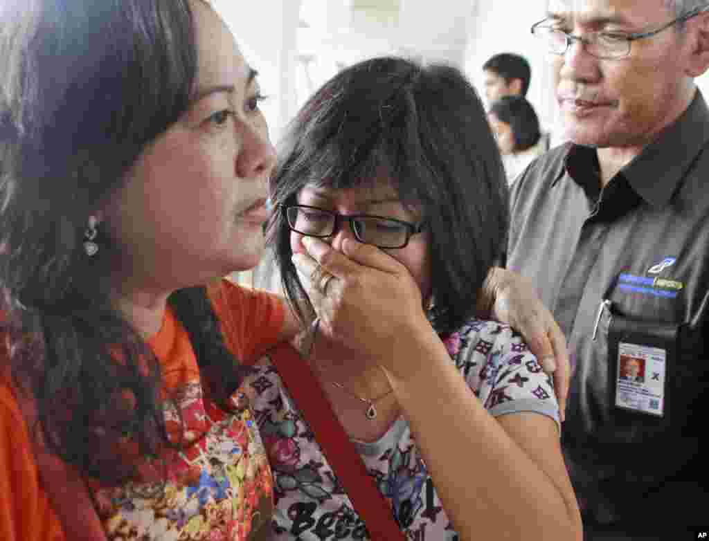 A relative of AirAsia flight QZ8501 passengers weeps as she waits for the latest news on the missing jetliner at Juanda International Airport in Surabaya, East Java, Indonesia, Dec. 28, 2014.