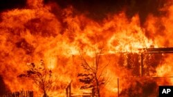 Flames consume a home as the River Fire tears though Lakeport, Calif., July 31, 2018.