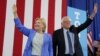 Democratic presidential candidate Hillary Clinton and Sen. Bernie Sanders stand together during a July 12 campaign rally in Portsmouth, N.H.
