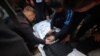 Para jurnalis berduka atas kematian rekan mereka, Mustafa Thuria, kamerawan untuk kantor berita AFP, yang tewas dalam serangan udara Israel, pada pemakamannya di Rafah di Jalur Gaza hari Minggu, 7 Januari 2024.