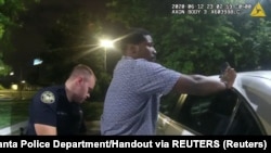 USA, Georgia, Atlanta, Former Atlanta Police Department officer Garrett Rolfe conducts a field sobriety test on 27-year-old Rayshard Brooks 