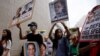 Supporters of Edward Snowden, a former CIA employee who leaked top-secret information about U.S. surveillance programs hold placards as they march to the Consulate General of the United States in Hong Kong Saturday, June 15, 2013.