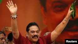 Sri Lanka's former president Mahinda Rajapaksa waves at his supporters as he arrives at a protest rally to launch a plan to topple the current government, accusing it of failing in its "management and development of the country" in Colombo, Sri Lanka, Jan. 27, 2017.