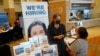 FILE - Marriott human resources recruiter Mariela Cuevas, left, talks to Lisbet Oliveros, during a job fair at Hard Rock Stadium, Sept. 3, 2021, in Miami Gardens, Florida.. 