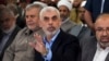 FILE - Yahya Sinwar, head of Hamas in Gaza, greets his supporters upon his arrival at a meeting in a hall on the sea side of Gaza City, on April 30, 2022.