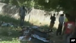 In this image made from television provided by the state-run Nigerian Television Authority, corpses are seen laid out following a series of coordinated attacks, Damatura, Nigeria, November 6, 2001.