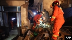 Rescue workers search a house for survivors after an earthquake in Kangdiao village, Dahejia, Jishishan County, in northwest China’s Gansu province on Dec. 19, 2023.