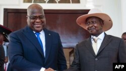 President of Democratic Republic of Congo (DRC) Felix Tshisekedi (L) shakes hands with Uganda's President Yoweri Museveni upon his arrival to discuss business between the two countries at the state house in Entebbe, Uganda, Nov. 9, 2019. 