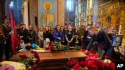 Люди віддають останню шану воїну-добровольцю, 36-річному Олександру Махову, відомому українському журналісту, убитому російськими військами. Михайлівський собор у Києві, 9 травня 2022 р. (AP Photo/Efrem Lukatsky )