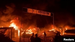 Fire rages following an Israeli strike on an area designated for displaced Palestinians, amid the ongoing conflict between Israel and Hamas, in Rafah in the southern Gaza Strip, in this still picture taken from a video, May 26, 2024.