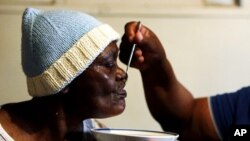 An AIDS patient is fed by a volunteer worker of the Sakhi-Sizwe AIDS care initiative in Orange Farm township, south of Johannesburg (file photo)