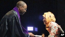 Ema Kastimah from Indonesia, right, one of more than 200,000 women who say they were forced into prostitution across Asia in 1930's and 1940's by Japanese government, receives a copy of the final judgement in the Sexual Slavery mock case from judge Willy