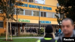 Police officers stand guard near the site of a shooting in front of a hospital in Ostrava, Czech Republic, December 10, 2019. REUTERS/Lukas Kabon