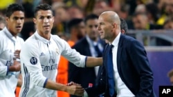 Cristiano Ronaldo de Real Madrid est félicité par son entraîneur Zinédine Zidane après avoir ouvert le score lors d’un match de la Champions League contre le Borussia Dortmund en Allemagne, le 27 septembre 2016.