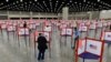 FILE - Voting stations are set up in the Kentucky Exposition Center for voters to cast their ballot in the Kentucky primary in Louisville, Ky., June 23, 2020. 