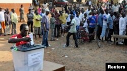 FILE - A man casts his vote at a polling station during presidential elections in Accra, Dec. 7, 2012.