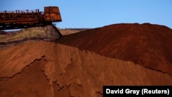 FILE - Mining company Rio Tinto shown unloading iron ore onto a pile at a mine located in the Pilbara region of Western Australia December 2, 2013. 