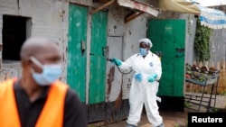 A Nairobi municipality worker sprays disinfectant in an effort to fight against the spread of the COVID-19 in the Kawangware neighborhood of Nairobi, Kenya, May 2, 2020.